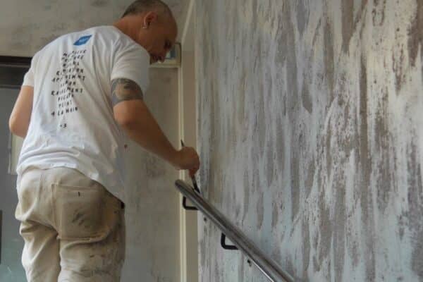 Un de nos peintre décorateur travaille sur une patine béton ciré dans un hôtel qui se veut industriel